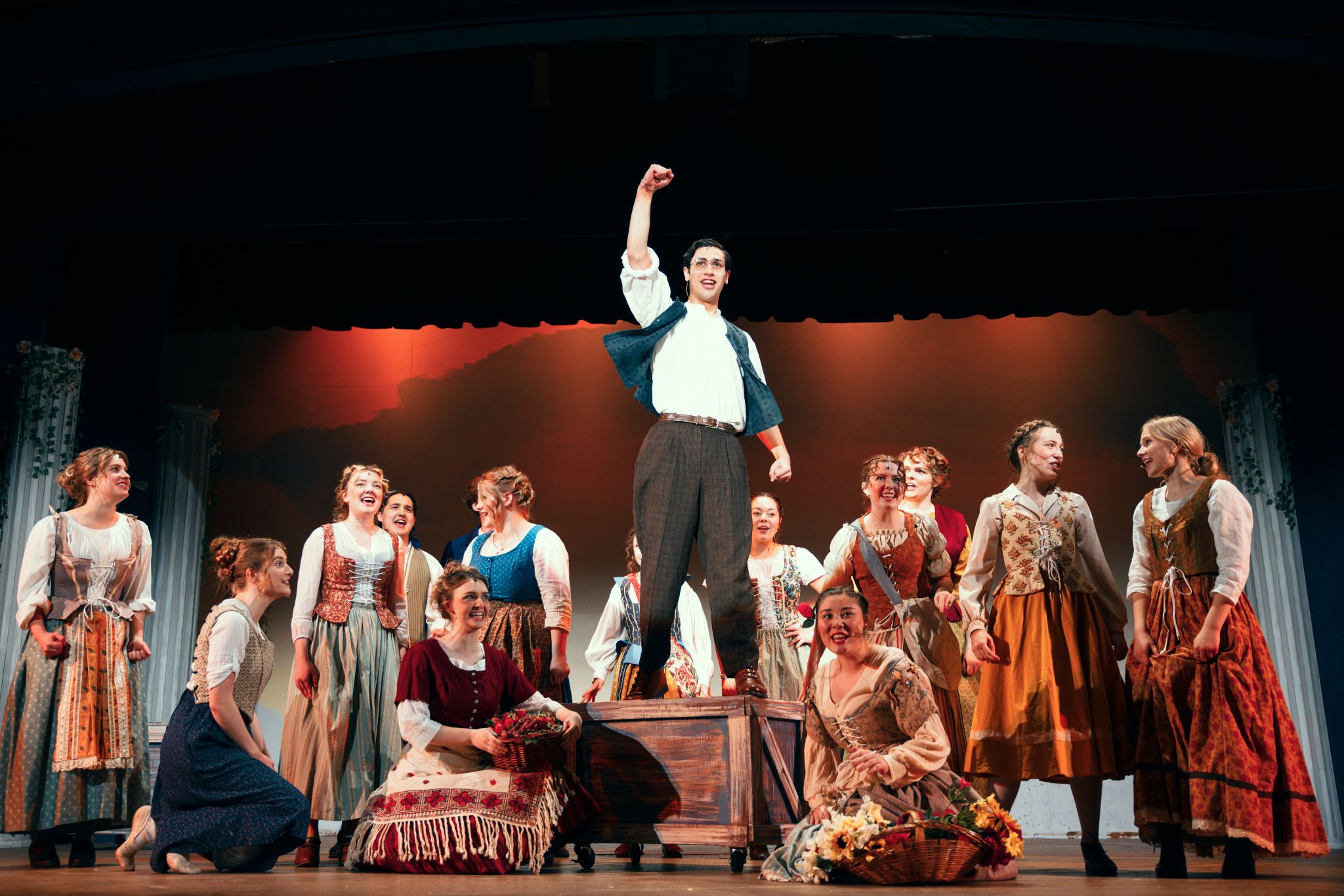 Colton Sorensen performing onstage with a theatrical ensemble