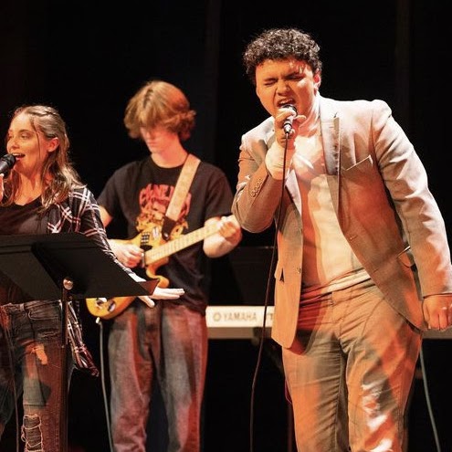 Colton singing with a band onstage